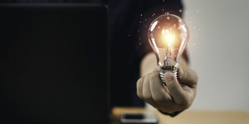 businessman-hand-holding-lightbulb-with-glowing-light-to-creative-smart-thinking-for-inspiration-and-innovation-with-network-concept-min-scaled.jpg